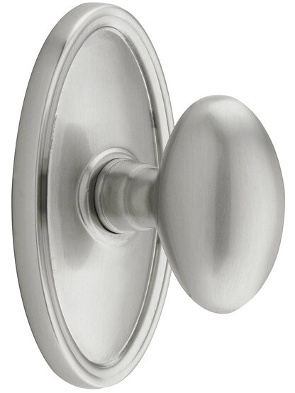 Oval Rosette Set With Elliptical Brass Knobs in Satin Nickel.